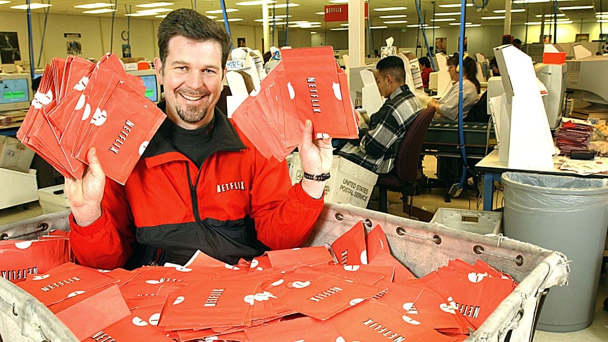 400303 02: Netflix.com Chief Executive Officer Reed Hastings sits in a cart full of ready-to-be-shipped DVDs January 29, 2002 in San Jose, CA. The online DVD rental site has 500,000 subscribers who can rent, receive and return unlimited discs per month by mail.