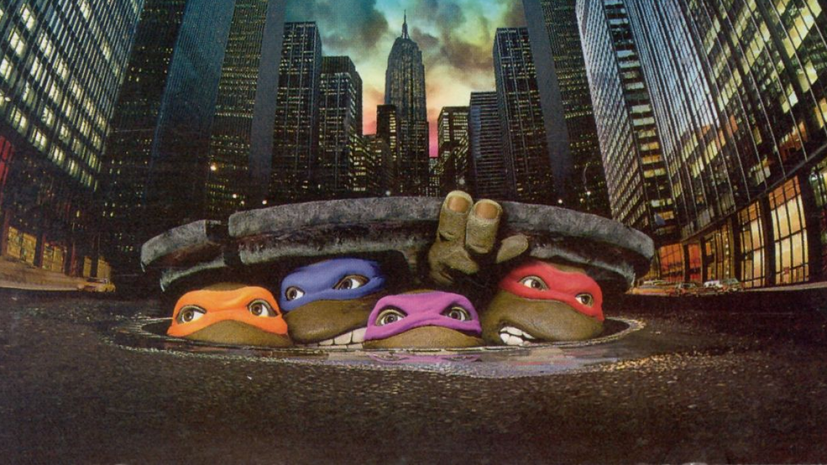 The Ninja Turtles coming out of a manhole against the New York City skyline