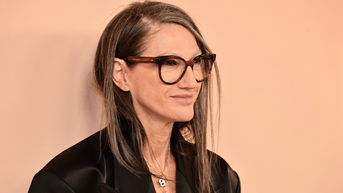 Jenna Lyons in glasses against a peach background