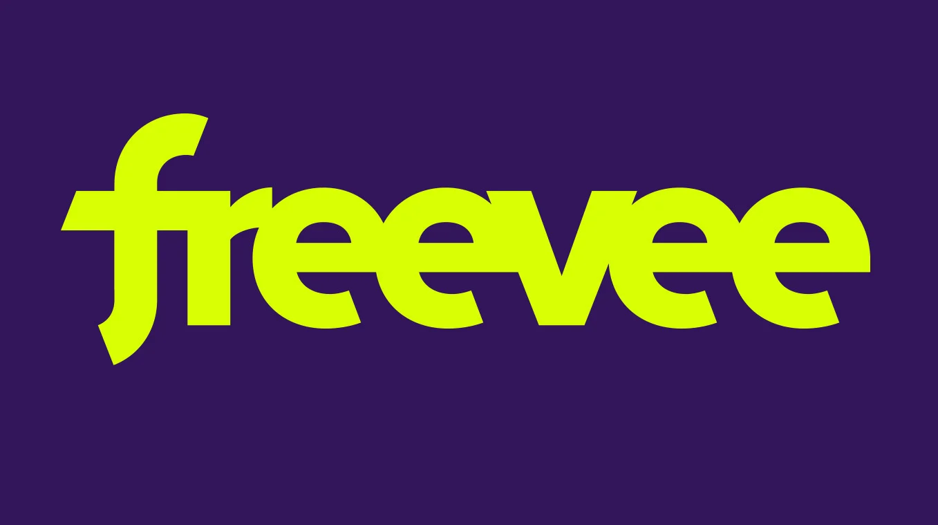 Neon green letters spell out "freevee" against a purple background. 