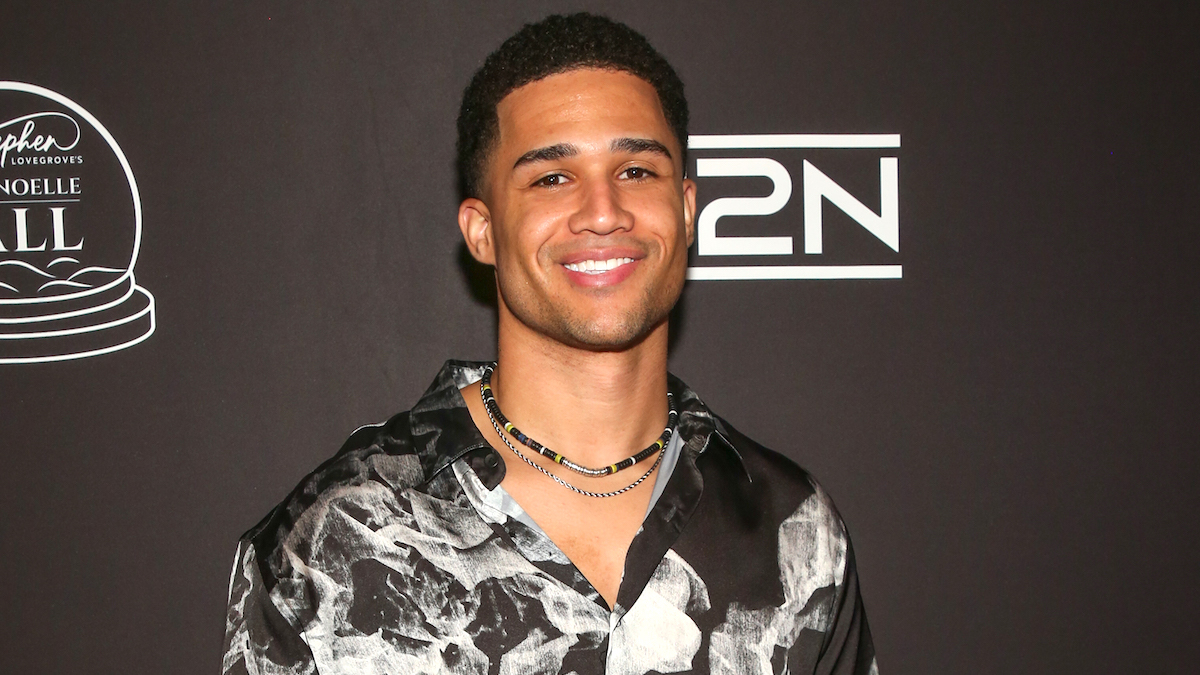 Aven Jones on the red carpet wearing a black floral t-shirt and a necklace