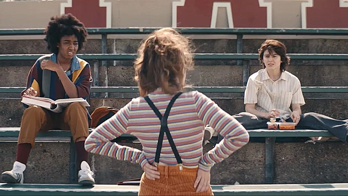 Ayo Edibiri and Ruby Cruz look confused as they talk to Rachel Sennott with her back to the camera in Emma Seligman's 2023 movie 'Bottoms'.