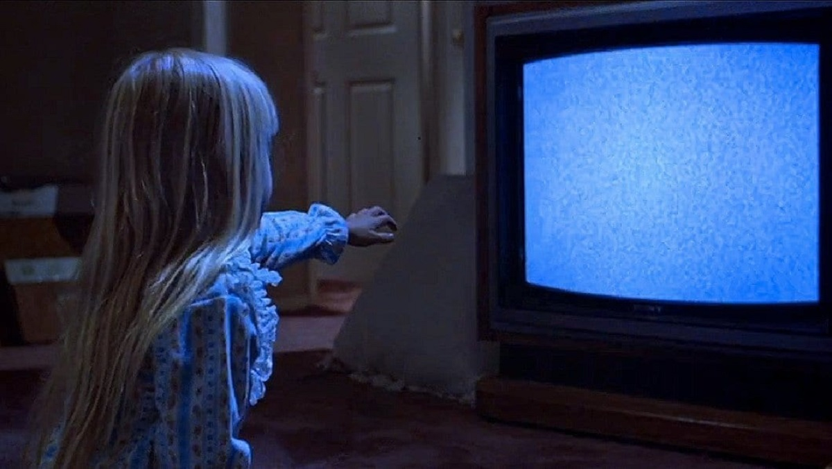Little girl watching static on the TV