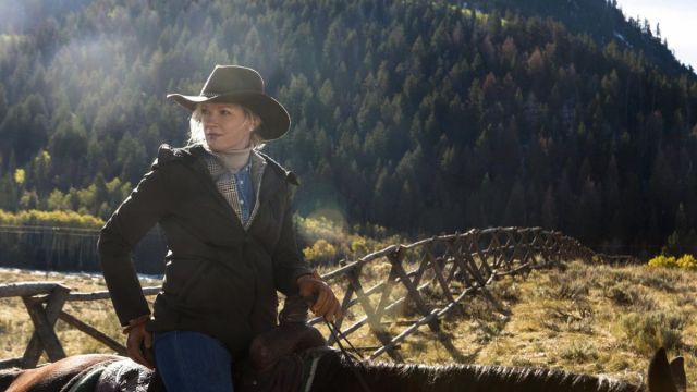 Evelyn Dutton stands against a fence in Yellowstone