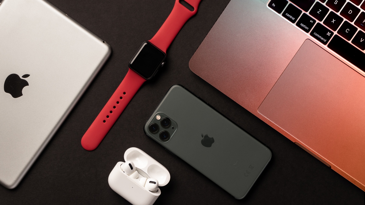 Flat Lay of different apple products on a grey background. - stock photo