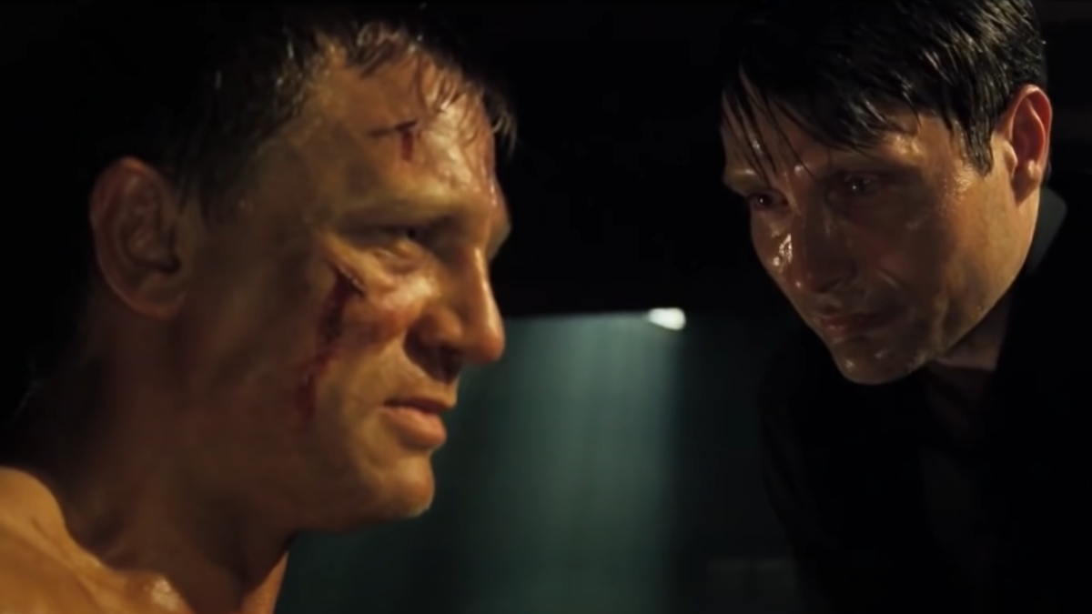 Le Chiffre torturing James Bond while both of them sweat excessively.