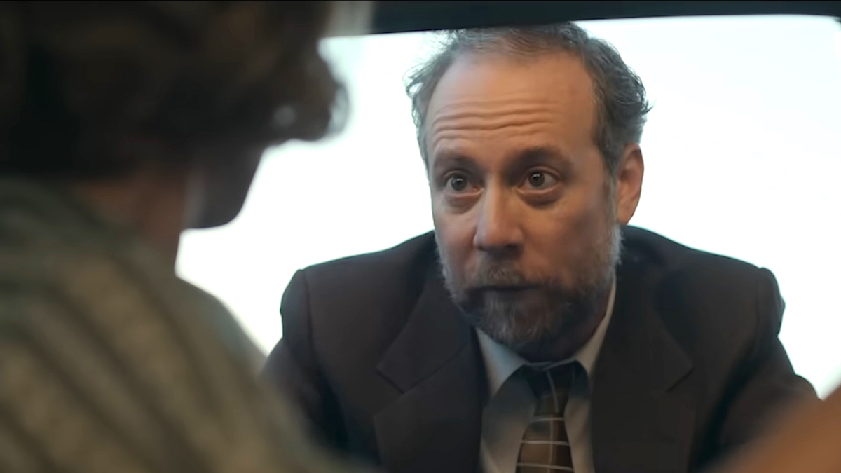Kevin Sussman as Walter leaning into a car window in Apple TV Plus' Lessons in Chemistry