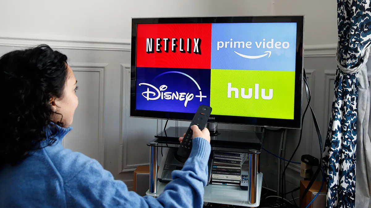 In this photo illustration, the logos of media service providers, Netflix, Amazon Prime Video, Disney + and Hulu are displayed on the screen of a television.