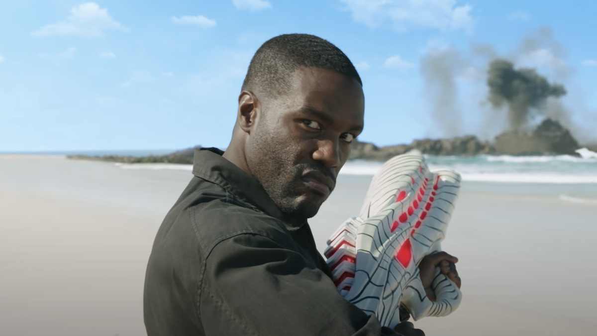 Yahya Abdul-Mateen II as Black Manta stands on a beach armed with an Atlantean gun in 'Aquaman and the Lost Kingdom' 