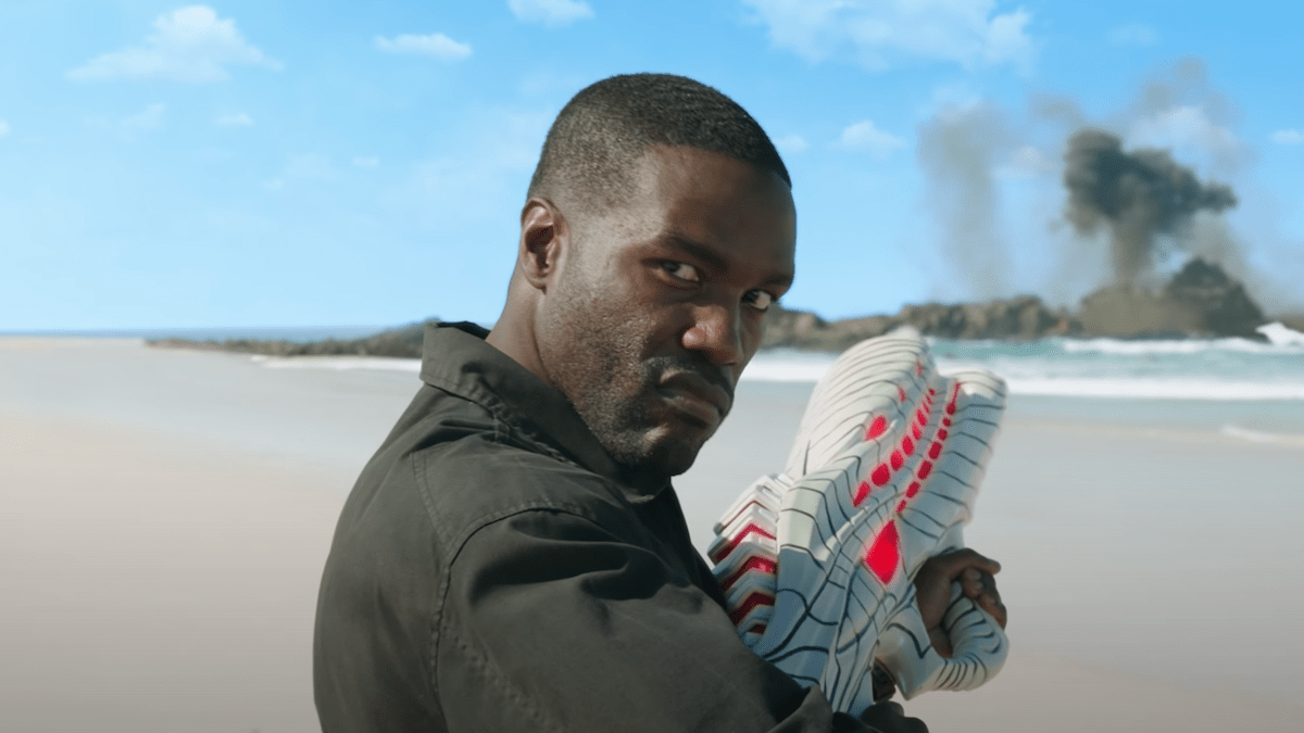 Yahya Abdul-Mateen II as Black Manta stands on a beach armed with an Atlantean gun in 'Aquaman and the Lost Kingdom'