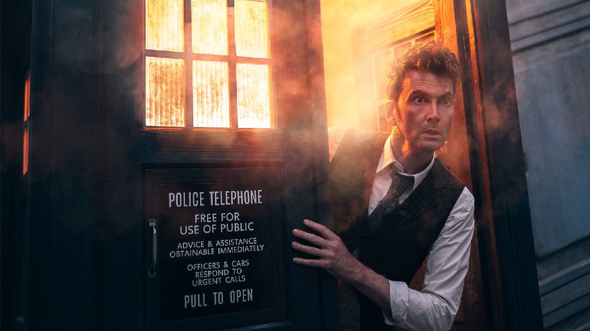 O décimo quarto Doctor de David Tennant emerge de uma TARDIS ardente e esfumaçada em uma imagem promocional dos especiais do 60º aniversário de Doctor Who. 