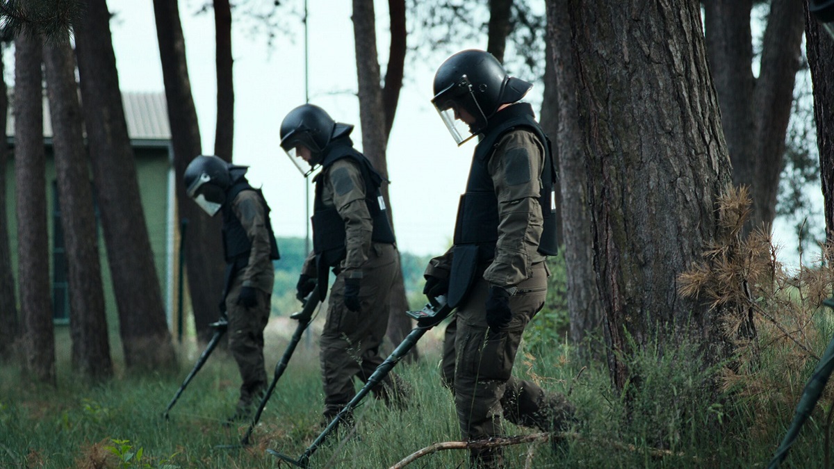 A group of heavily-armed militia patrol a forest in 'Dear Child'