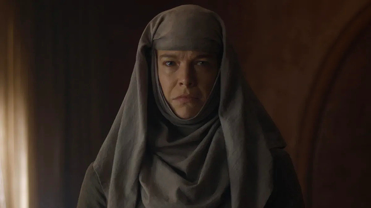 Hannah Waddingham as Septa Unella in 'Game of Thrones.' is standing in a dark room.