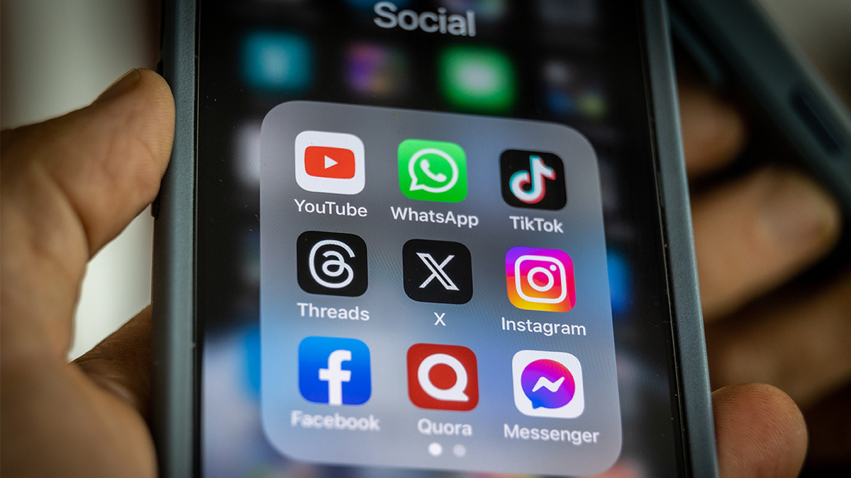 In this photo illustration the logo of US online social media and social networking site 'X' (formerly known as Twitter) is displayed centrally on a smartphone screen alongside that of Threads (L) and Instagram (R). On the top row the logo of online video sharing and social media platform YouTube is seen alongside that of Whatsapp and TikTok. Along the bottom row Facebook, Quora and Messenger are displayed.