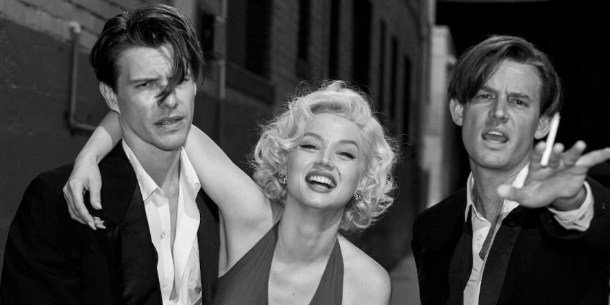 In "Blonde", Marilyn Monroe has her arm around Charlie "Cass" Chaplin Jr. and Eddy G. Robinson Jr. stands near. 