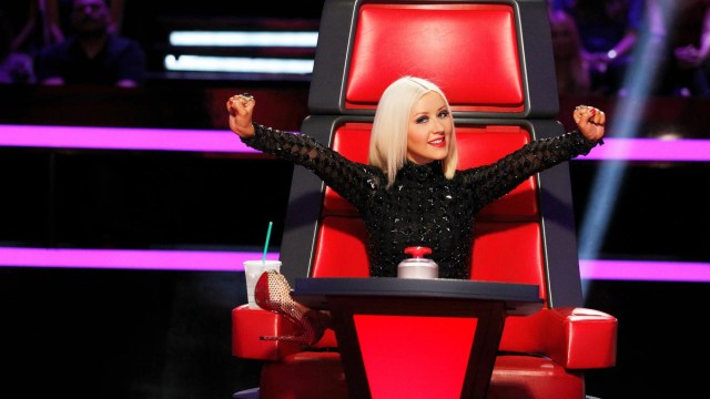 Christina Aguilera sitting on the coaches' chair during season 5 of 'The Voice'.