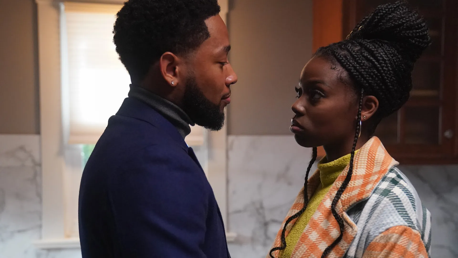Two characters in "The Chi" are having a conversation in the kitchen.