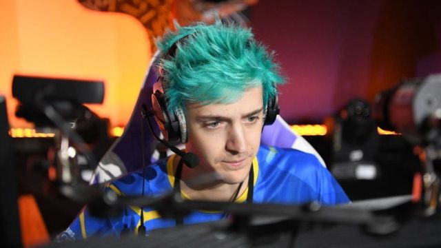 Ninja is sitting at his computer with his headset on.