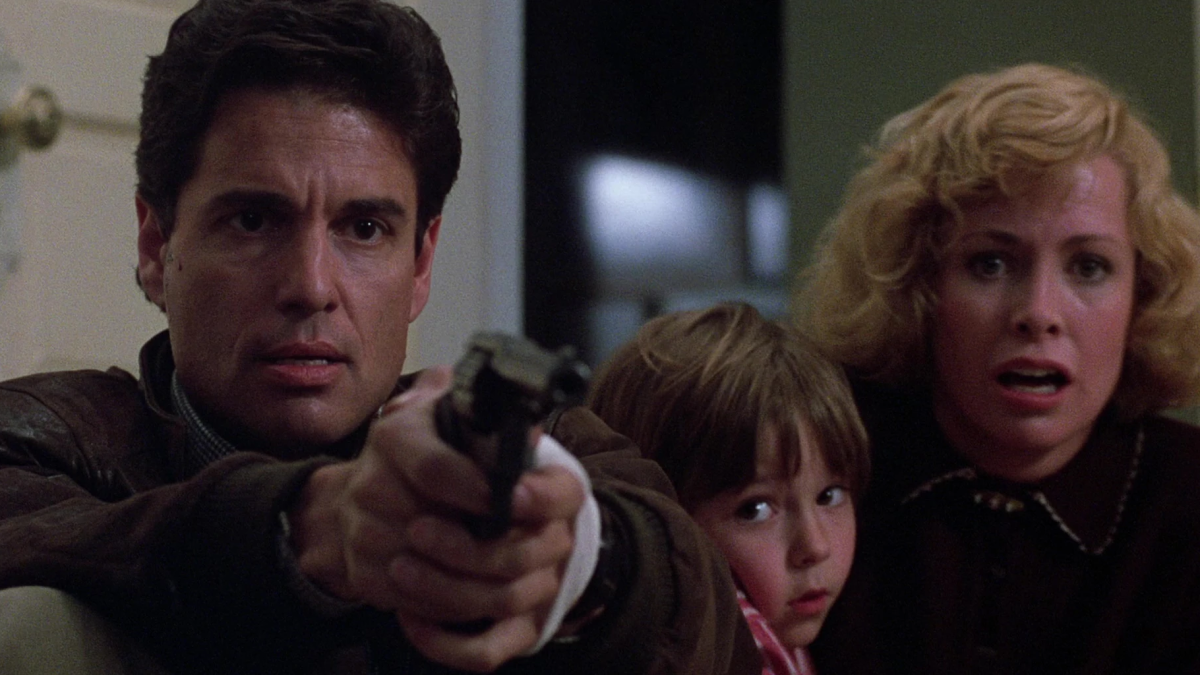 Mike Norris holding a gun next to Karen and Andy Barclay in 'Child's Play'