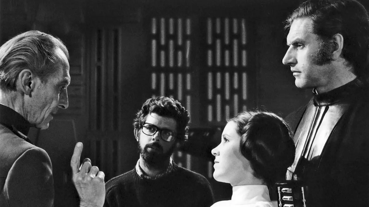 British actors Peter Cushing, David Prowse and American Actress Carrie Fisher with director, screenwriter and producer George Lucas on the set of his movie Star Wars: Episode IV - A New Hope. (Photo by Sunset Boulevard/Corbis via Getty Images)