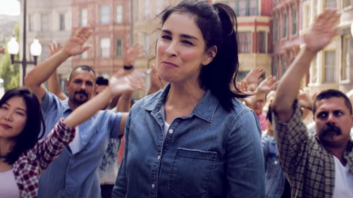 Sarah Silverman in front of background dancers in "I Love You America"