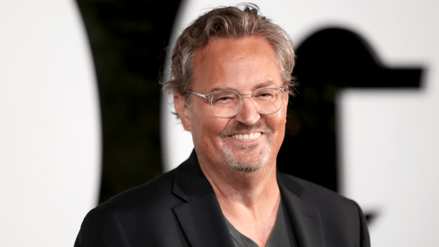 Matthew Perry smiles at a camera during a red carpet event