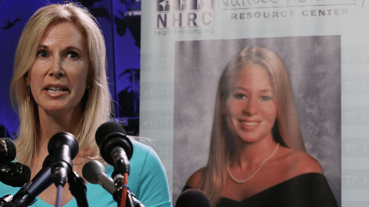 Beth Holloway stands in front of a picture of daugher, Natalee.