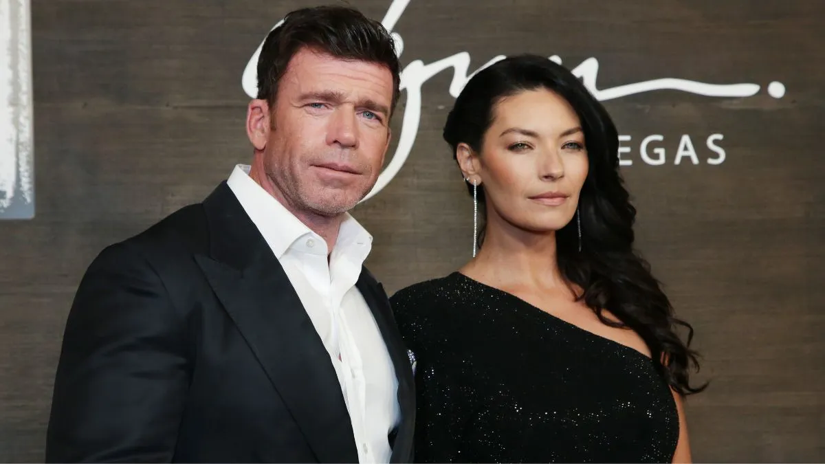 Nicole Muirbrook and Taylor Sheridan pose for a photo on a red carpet.