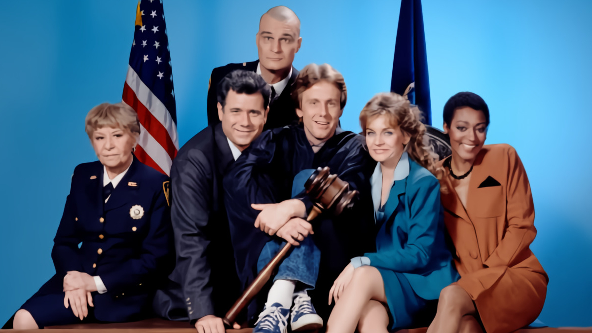 The original cast of night court holding a giant gavel.