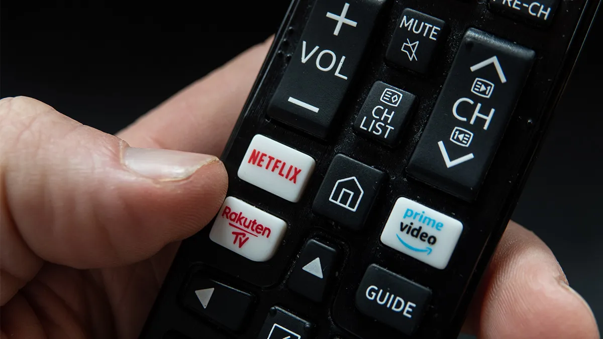 In this photo illustration, a TV remote control with Netflix and Amazon Prime Video streaming platform buttons is seen.
