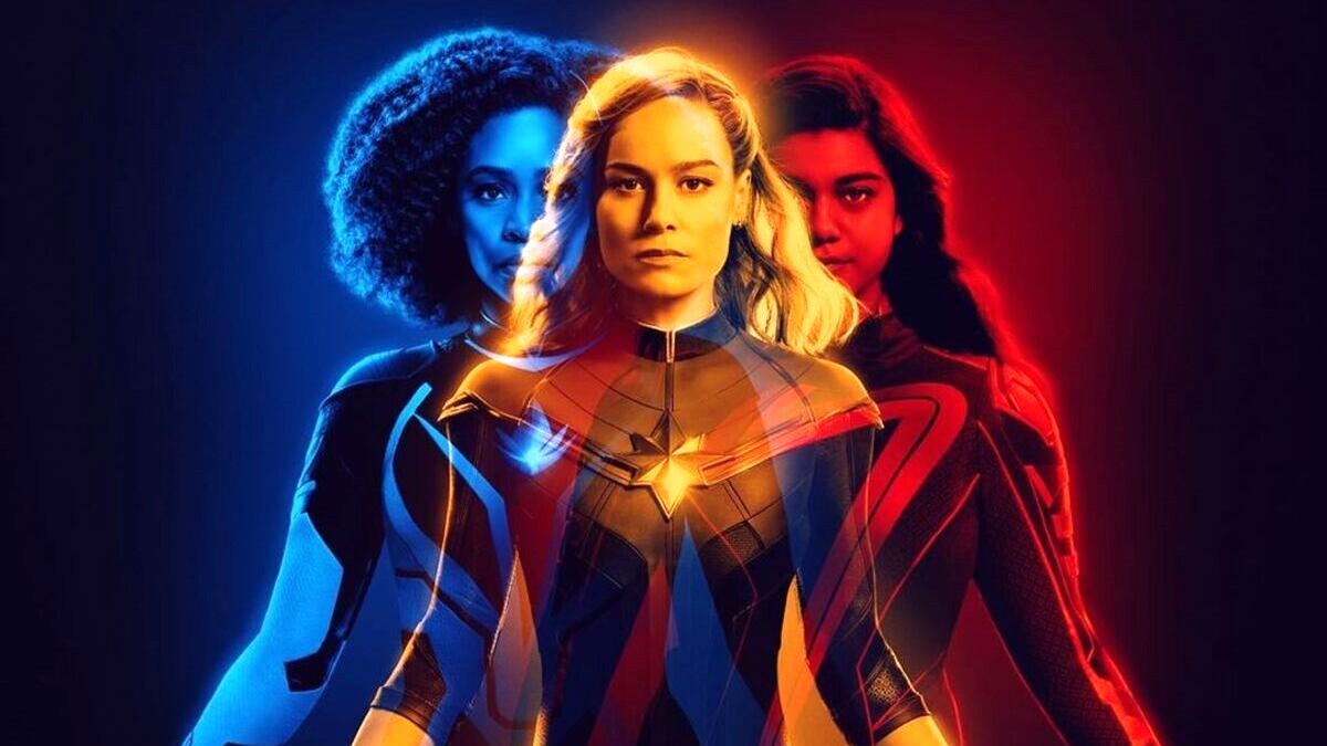 Teyonah Parris, Brie Larson, and Iman Vellani star in the blue, yellow, and red-hued Read D 3D poster for 'The Marvels.'