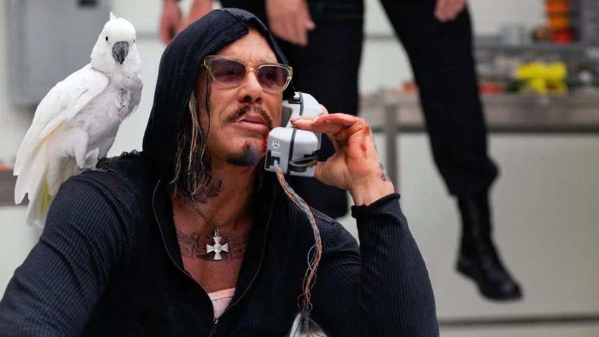 Ivan Vanko/Whiplash talks on the phone with his pet bird on his shoulder in 'Iron Man 2.'