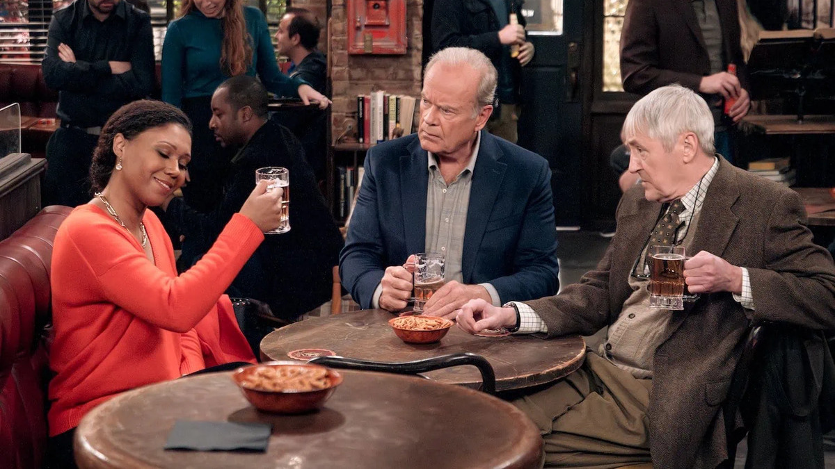 Frasier (Kelsey Grammer), Alan (Nicholas Lyndhurst), and Olivia (Toks Olagundoye) raise a glass at a bar in the 'Frasier' reboot. 