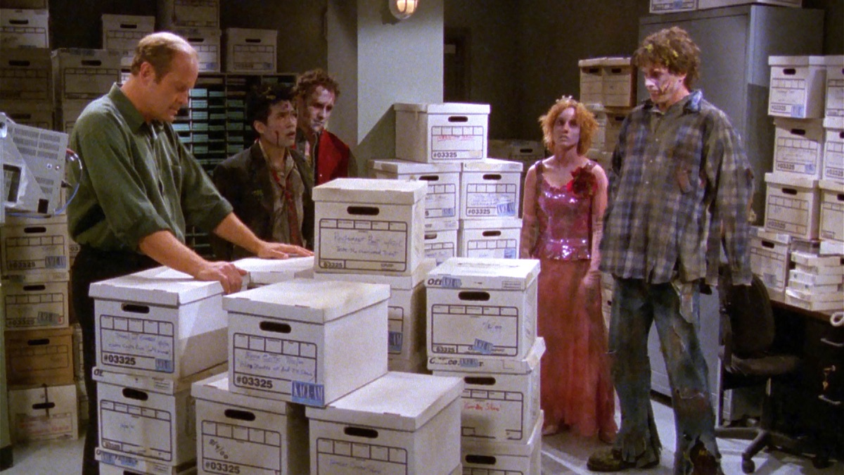 Frasier Crane (Kelsey Grammer) is uniwttingly surrounded by zombies.