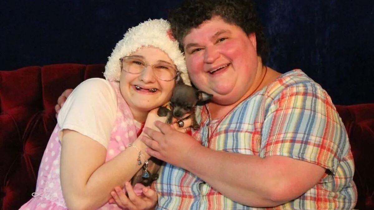 Gypsy Rose and her mother are posing for a picture with a dog.
