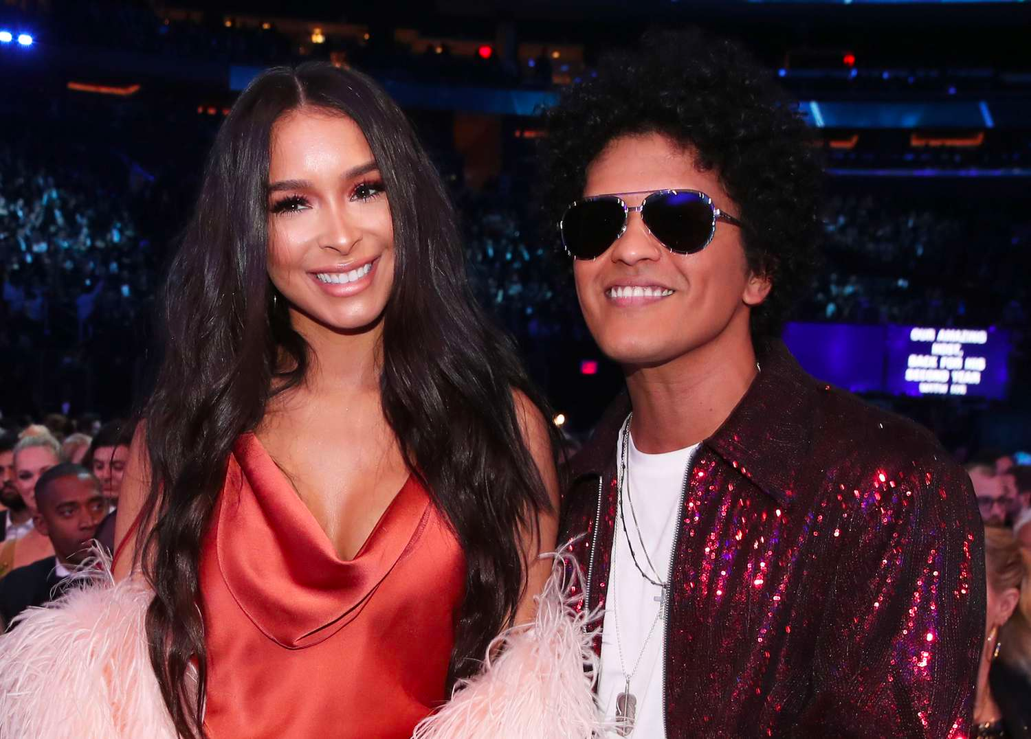 Bruno Mars and Jessica Cuban are smiling for a picture. 
