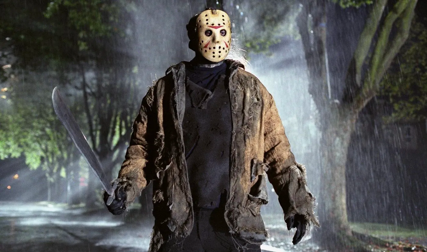 Jason is wearing a mask and holding a weapon in Friday the 13th.
