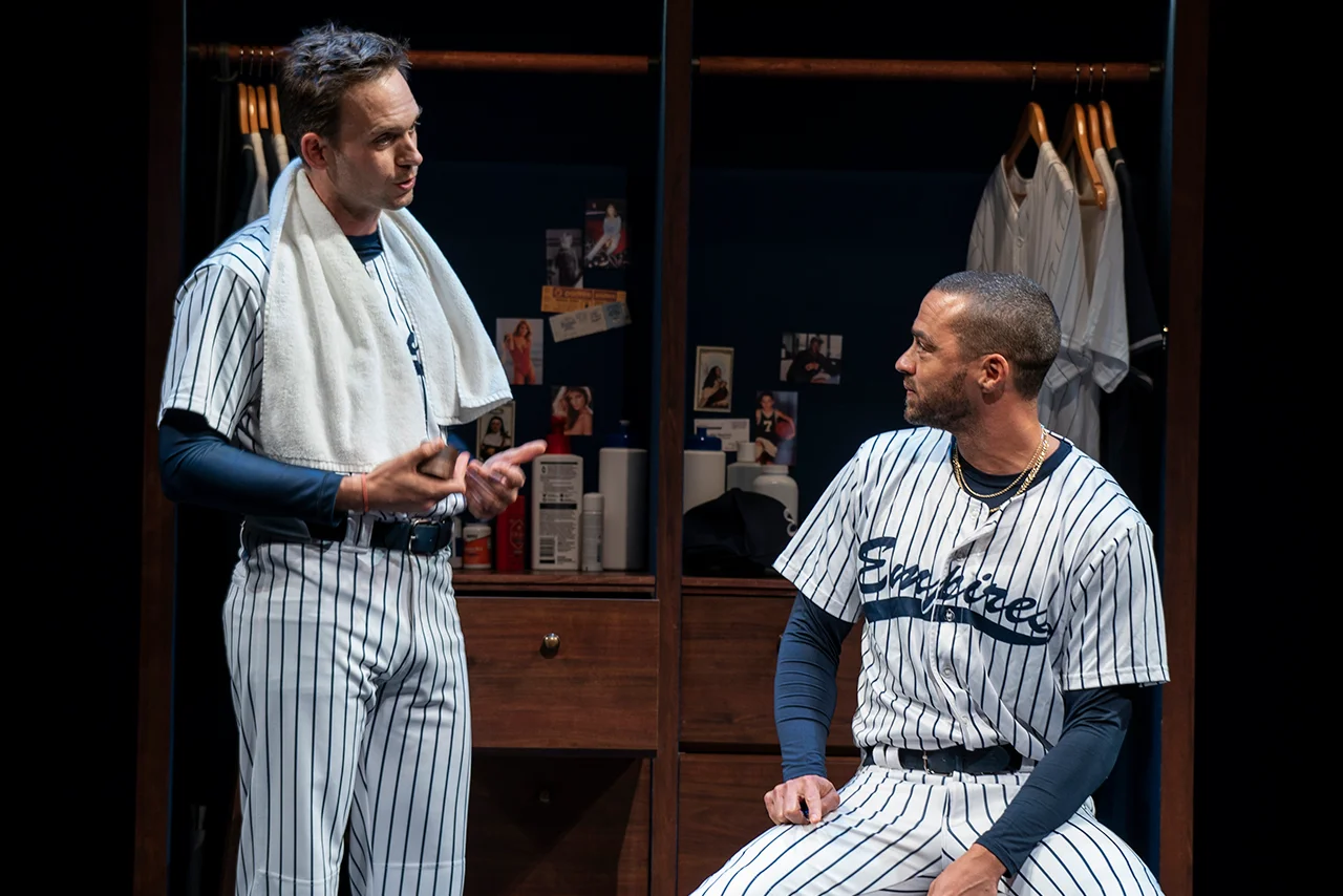 Patrick J. Adams and Jesse Williams are dressed like baseball players. 