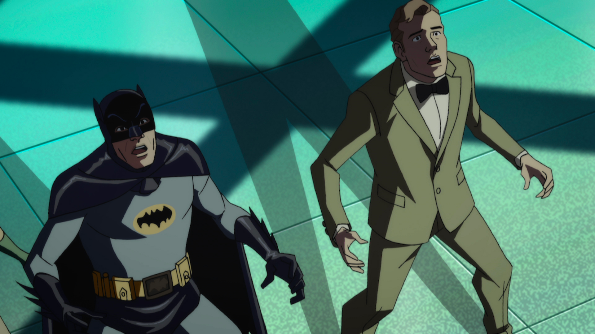 Batman and a man in a suit look shocked. 
