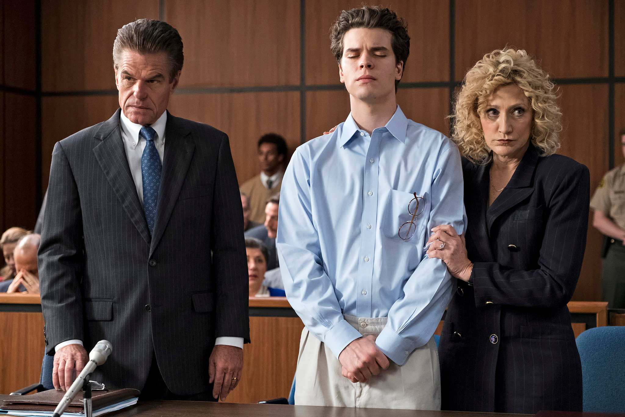 Three characters stand in a courtroom in Law & Order True Crime.