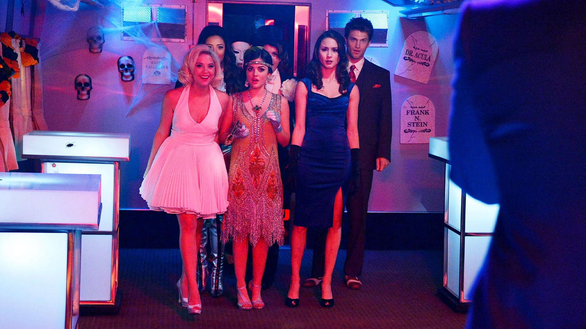 The cast of Pretty Little Liars is walking into a Halloween party.
