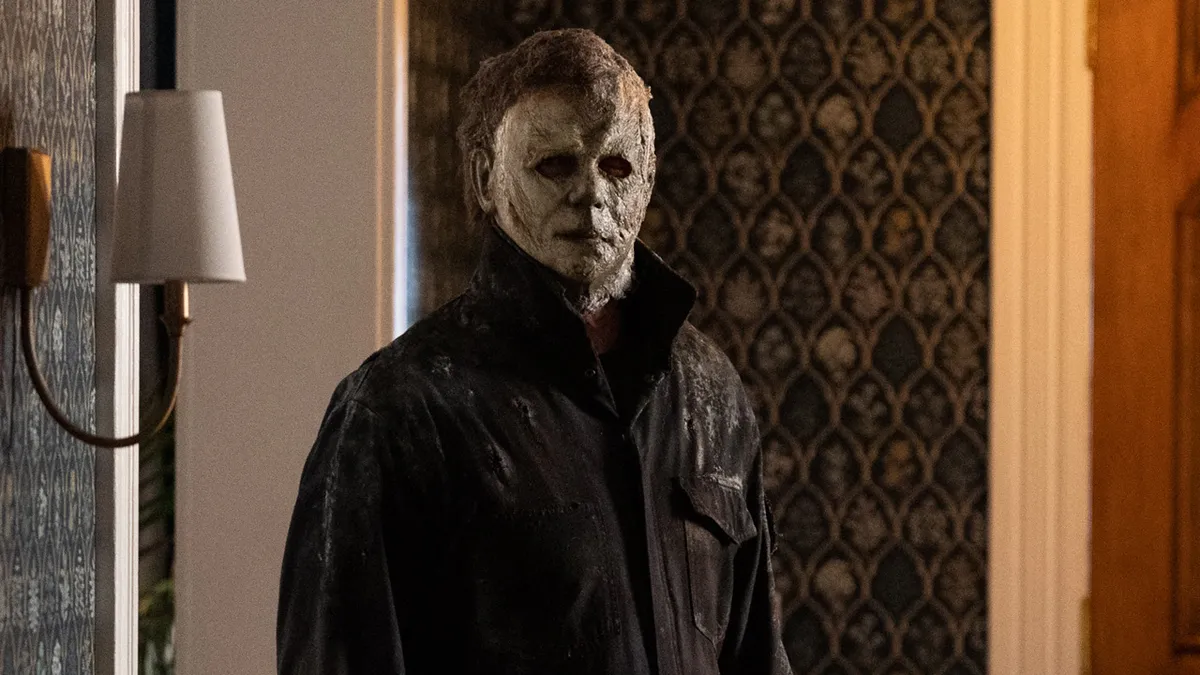 Michael Myers is standing in a hotel room. 
