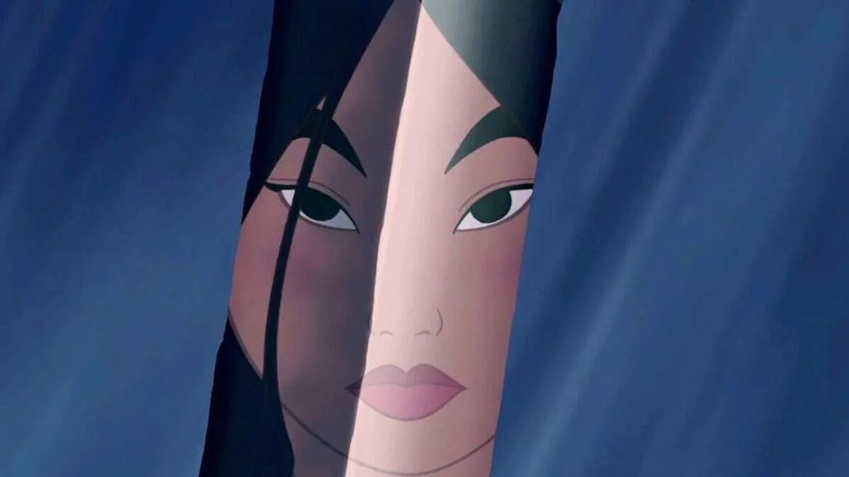 Mulan's reflection shows in her sword as she prepares to cut her hair