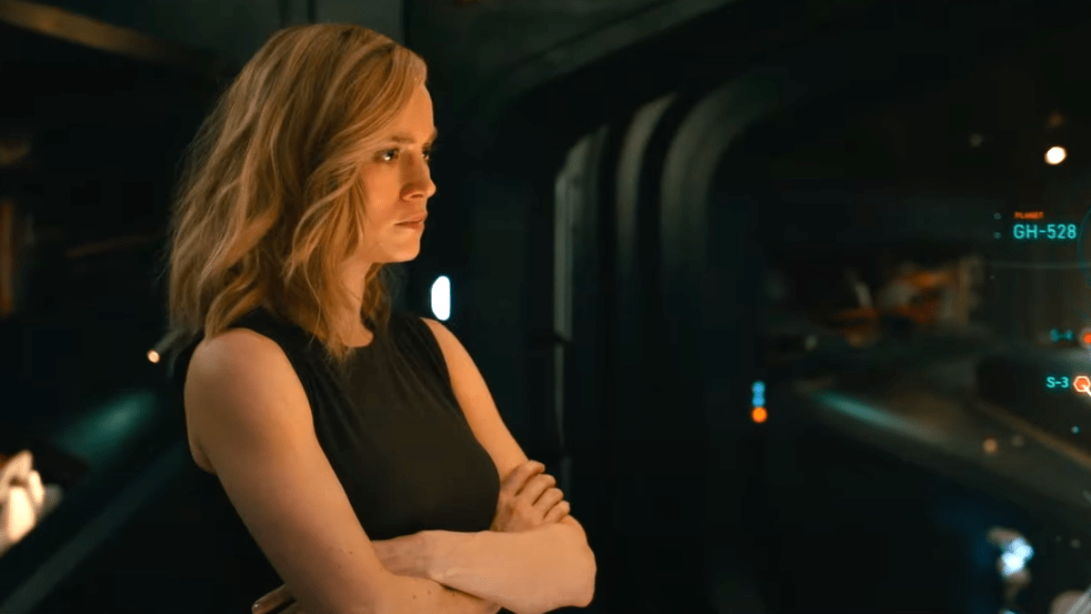 Brie Larson's Captain Marvel frowns and folds her arms in 'The Marvels'