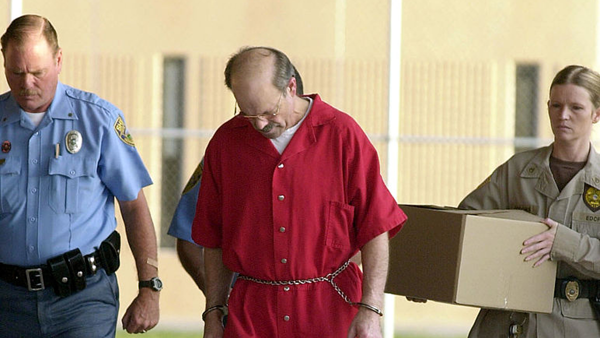 Dennis L. Rader (L), the man admitting to be the BTK serial killer, is escorted into the El Dorado Correctional Facility on August 19, 2005 in El Dorado, Kansas. Dennis Rader of Park City, Kansas pleaded guilty to the 10 killings dating back to 1974. Rader received 10 life terms and a "hard 40" for the ten murders he committed over nearly 30 years. 