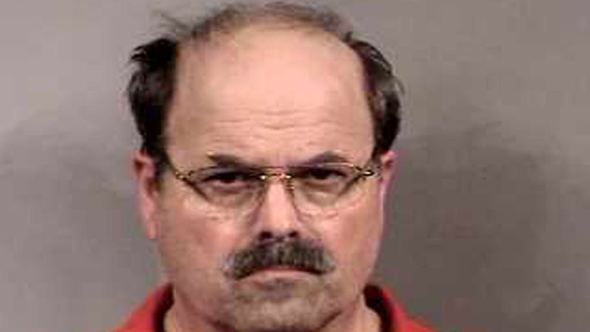 In this handout image provided by the Sedgwick County Sheriff's office, BTK murder suspect Dennis Rader stands for a mug shot released February 27, 2005 in Sedgwick County, Kansas. Rader is the suspect whom police have arrested on suspicion of first-degree murder in connection with the 10 deaths now tied to the serial killer known as BTK. 