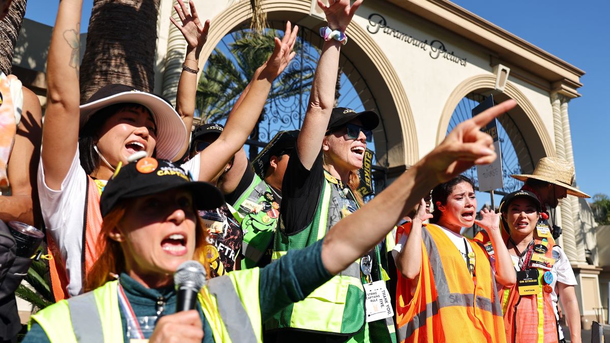 SAG-AFTRA members chant outside Paramount Studios on day 118 of their strike against the Hollywood studios on November 8, 2023 in Los Angeles, California. A tentative labor agreement has been reached between the actors union and the Alliance of Motion Picture and Television Producers (AMPTP) with the strike set to end after midnight. (Photo by Mario Tama/Getty Images)