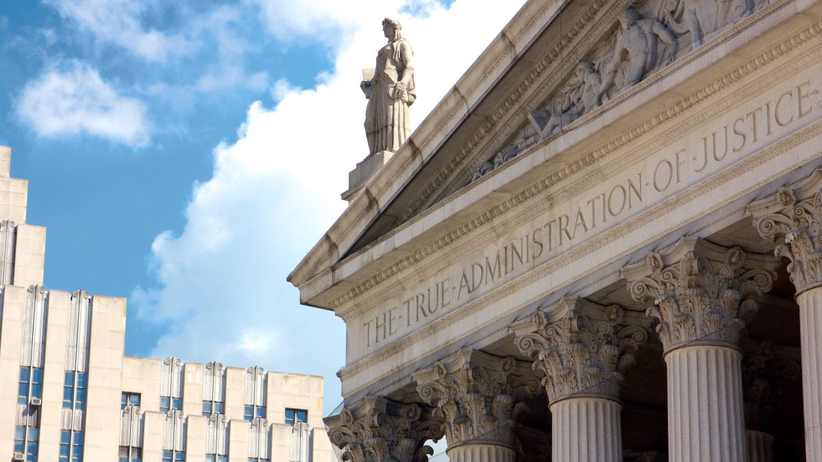 New York State Supreme Court building in Lower Manhattan showing the words "The True Administration of Justice" on its facade in New York, NY, USA.