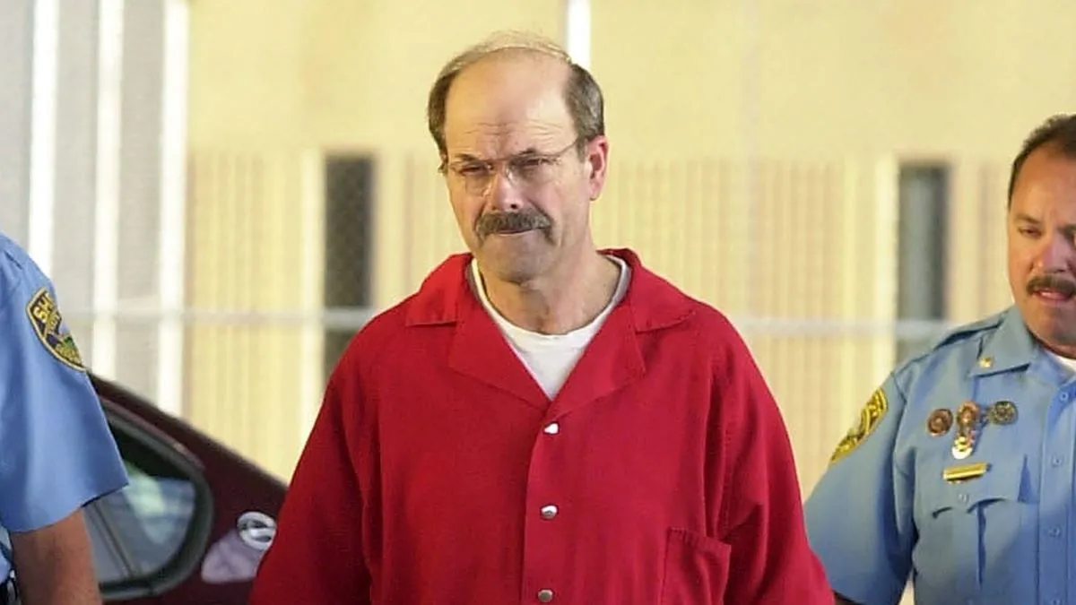 Dennis L. Rader (L), the man admitting to be the BTK serial killer, is escorted into the El Dorado Correctional Facility on August 19, 2005 in El Dorado, Kansas. Dennis Rader of Park City, Kansas pleaded guilty to the 10 killings dating back to 1974. Rader received 10 life terms and a "hard 40" for the ten murders he committed over nearly 30 years. (Photo by Jeff Tuttle-Pool/Getty Images)