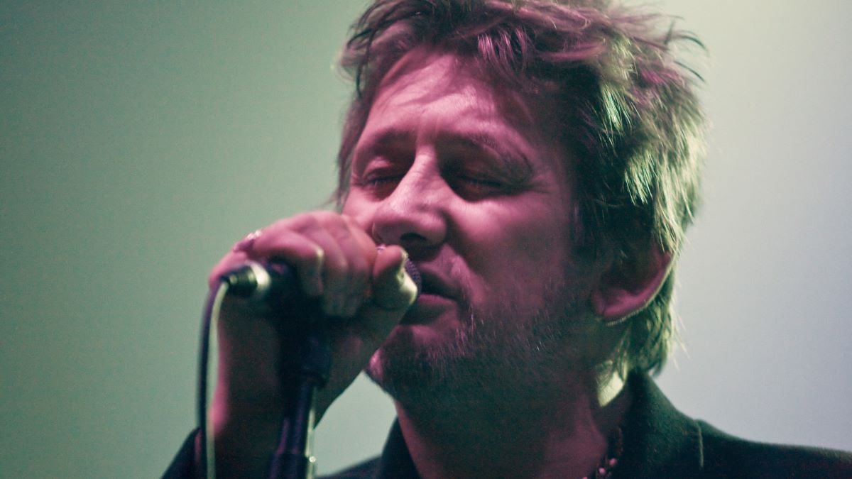 Photo of POGUES and Shane MacGOWAN, Shane MacGowan performing on stage (Photo by Matt Kent/Redferns)